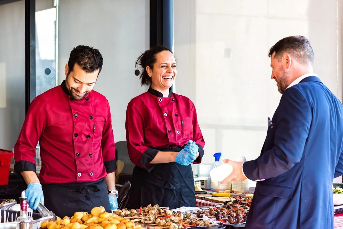 People serving pasta